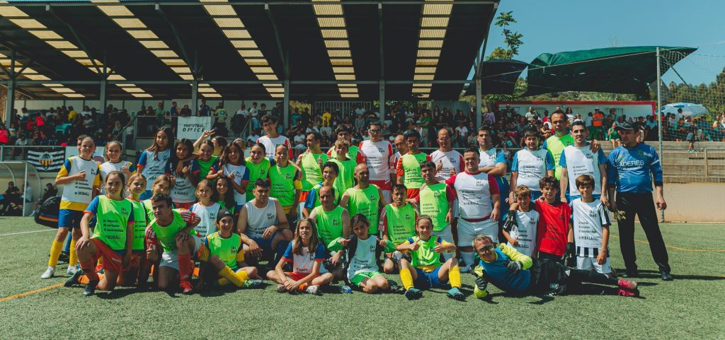 Personas de equipos de fútbol femenino, masculino y de diversidad funcional posan en grupo